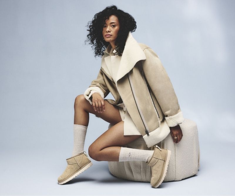 Woman in a shearling jacket wearing suede mini boots