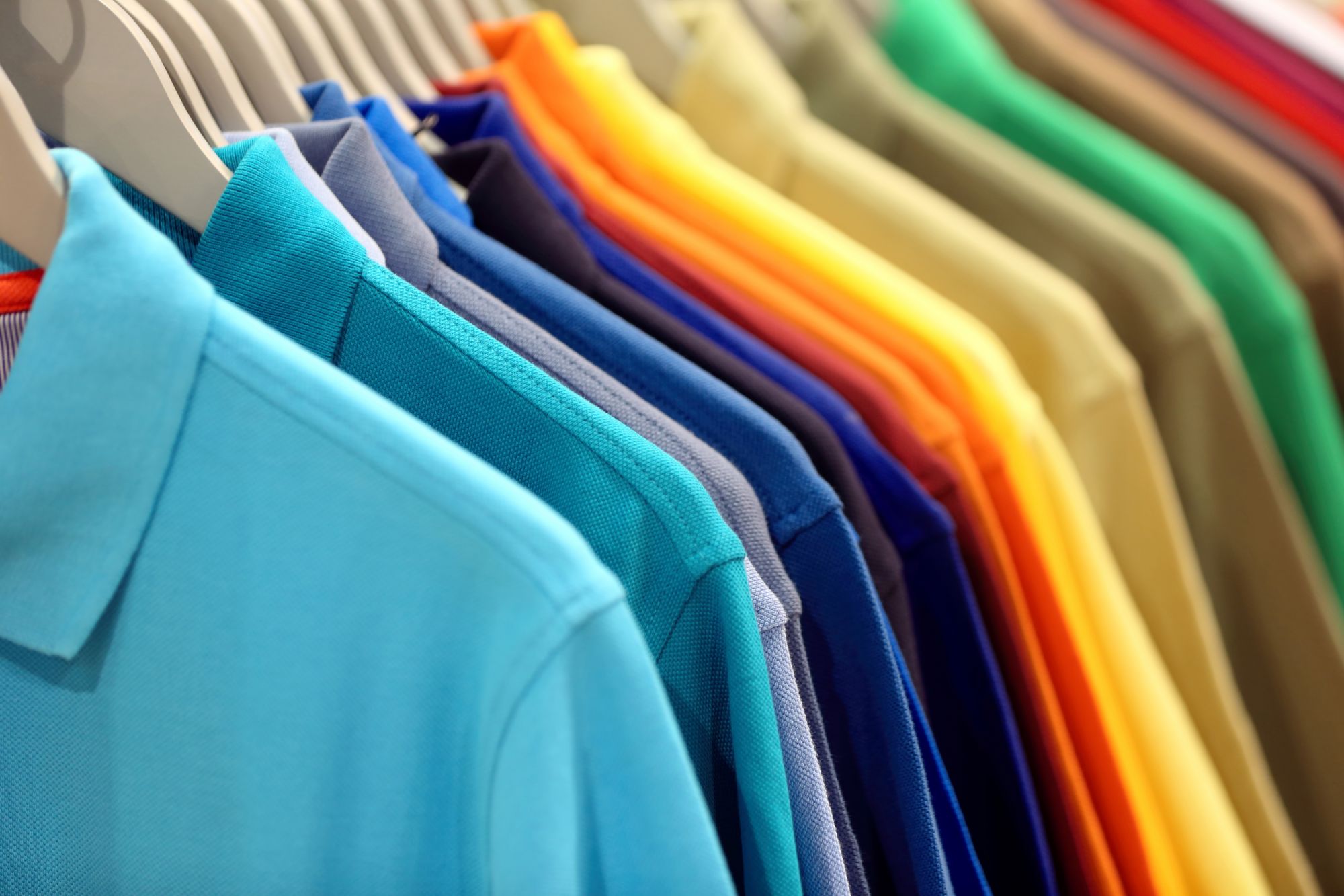 Rack of colourful polo shirts ready to ship